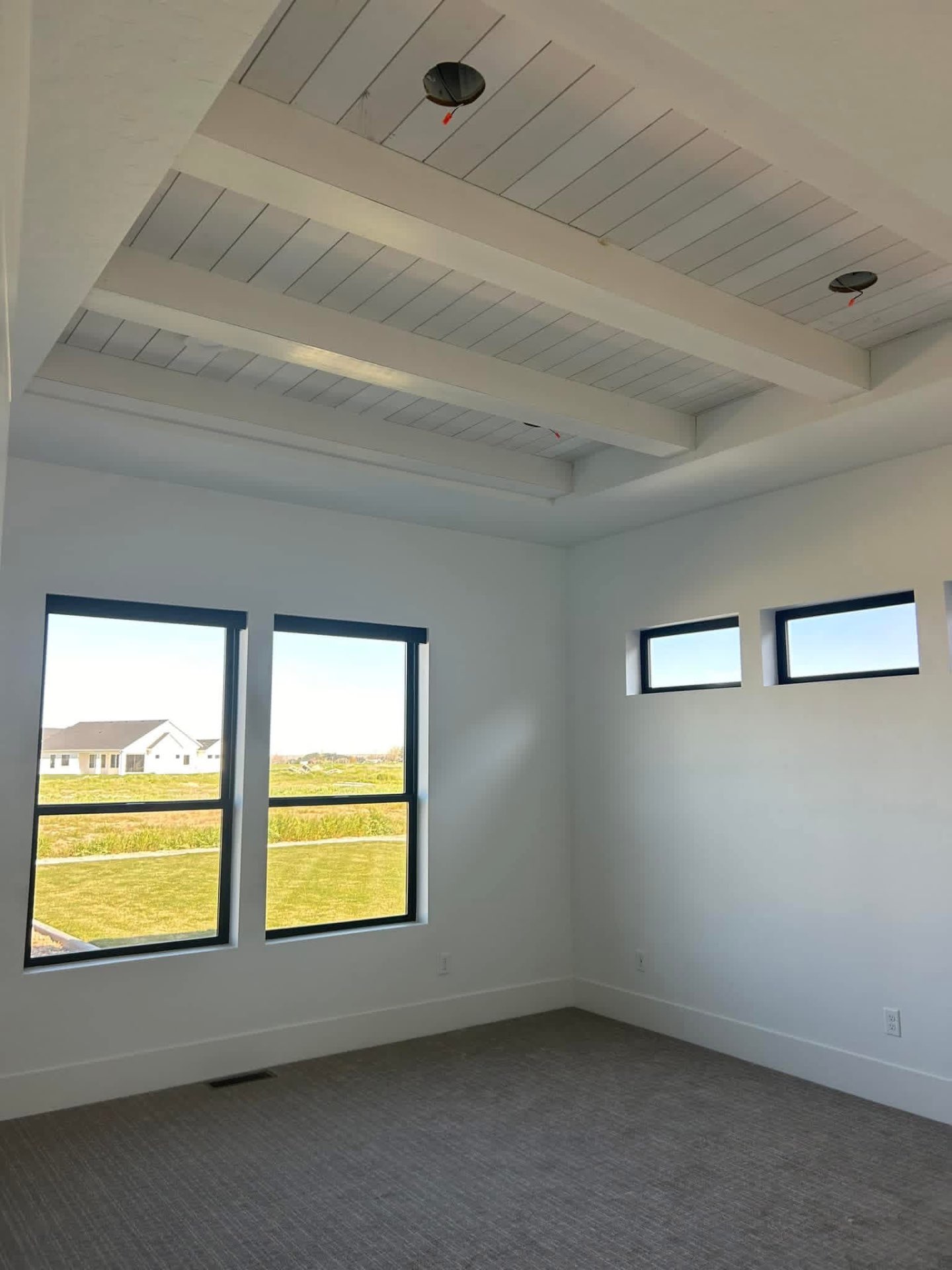 Coffered shiplap ceiling with white beams