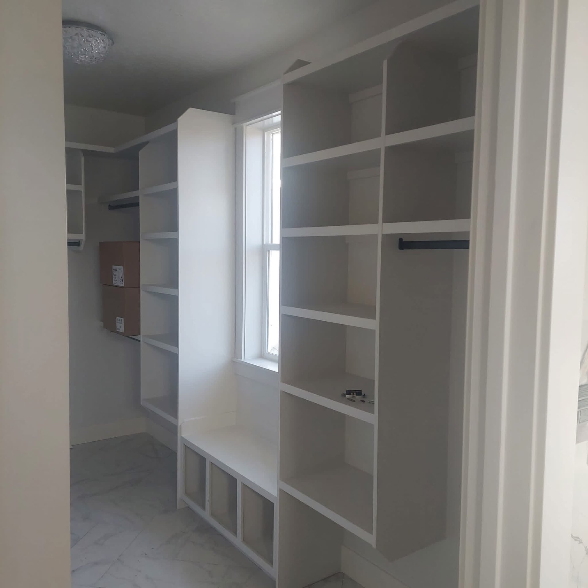 Custom built-in closet with shelving and bench seat